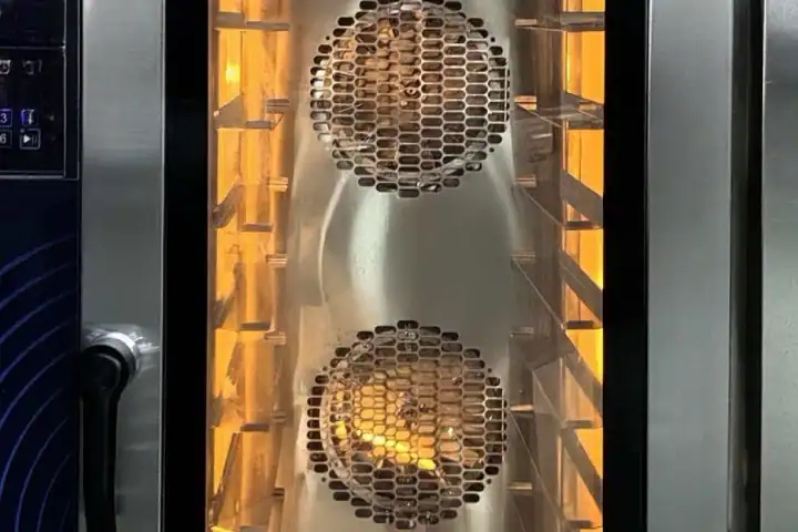 Rear-mounted fan with perforated stainless-steel air guide inside a GLEAN commercial convection oven