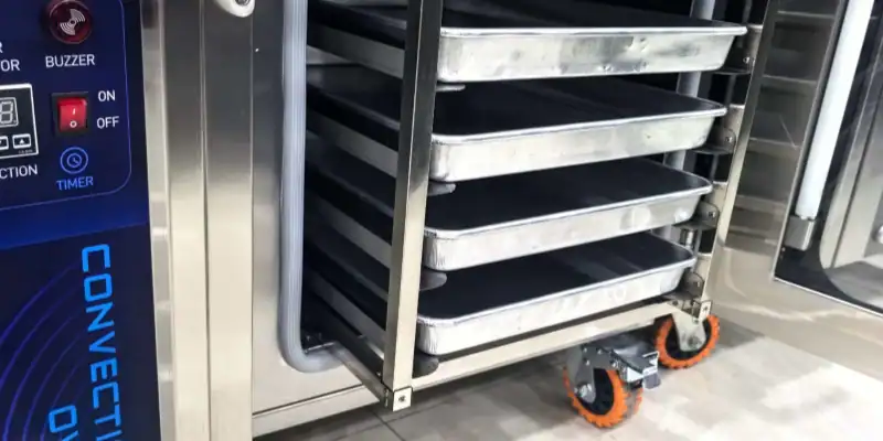 Removable internal tray rack in a GLEAN commercial convection oven, slid out for easier chamber cleaning