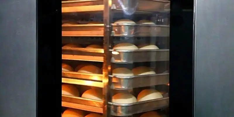 Rotary baking rack inside GLEAN commercial convection oven loaded with bread dough during baking cycle