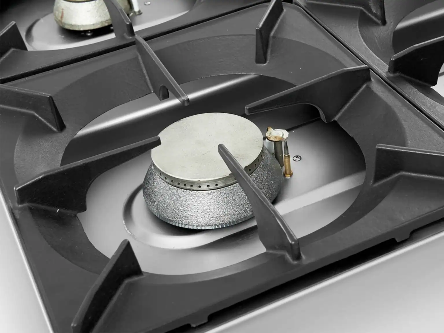 Cast iron burner and pan support detail on a modular commercial cooking range