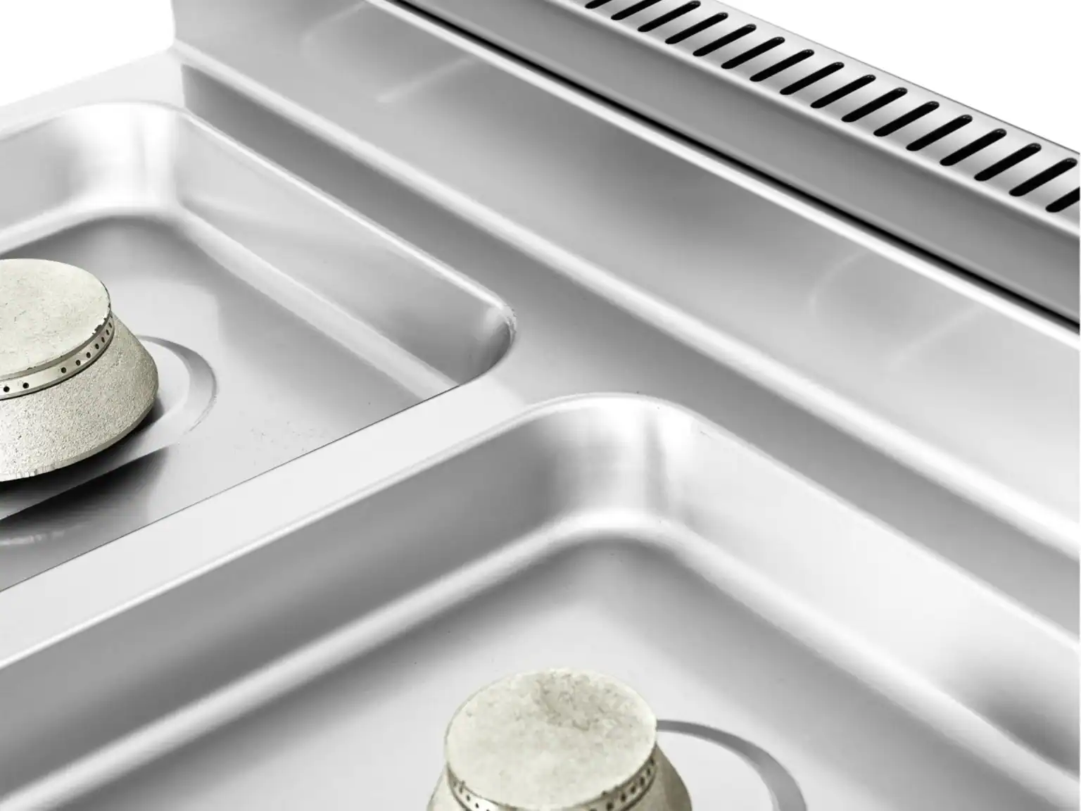 Pressed one-piece stainless steel worktop and rear flue detail on a modular cooking range